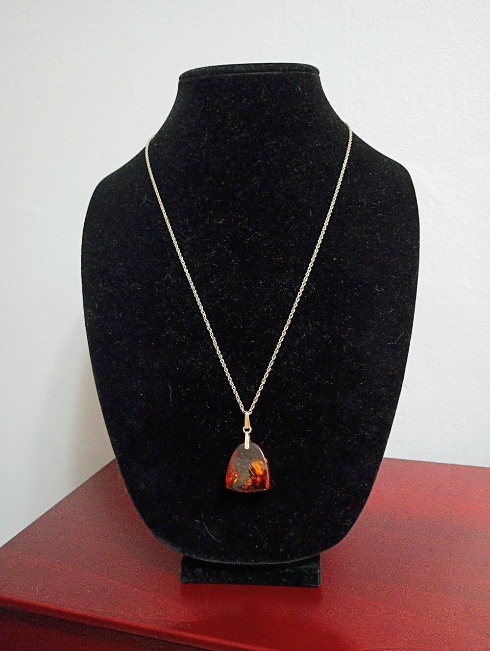 Natural Baltic Amber, which hangs from a Silver Toned Chain Necklace